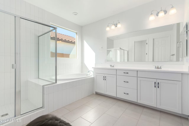 bathroom with tile patterned flooring, vanity, and plus walk in shower