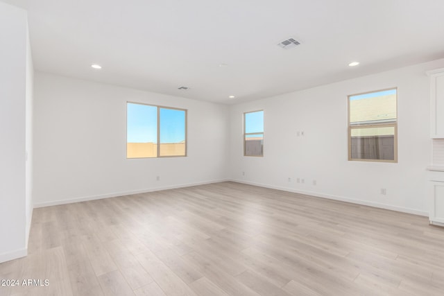 empty room with light hardwood / wood-style flooring