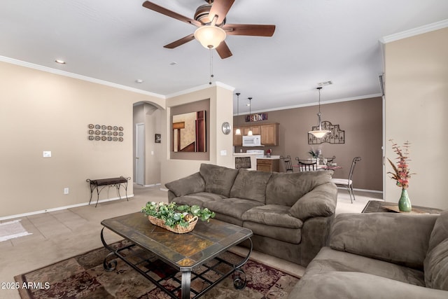 carpeted living room featuring ornamental molding and ceiling fan