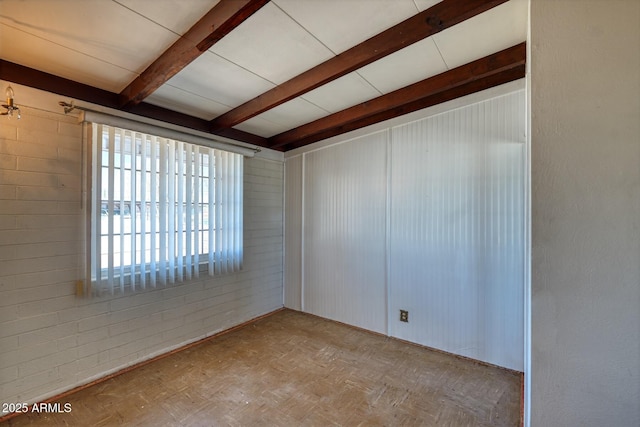 spare room featuring beam ceiling