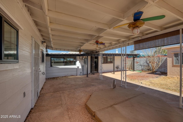 view of patio with a ceiling fan and fence