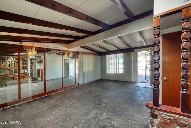 spare room with tile patterned floors and vaulted ceiling with beams