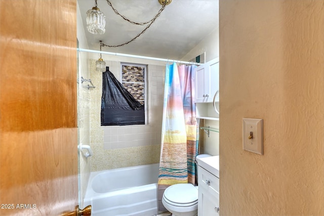 bathroom with a textured wall, toilet, vanity, and shower / bath combination with curtain