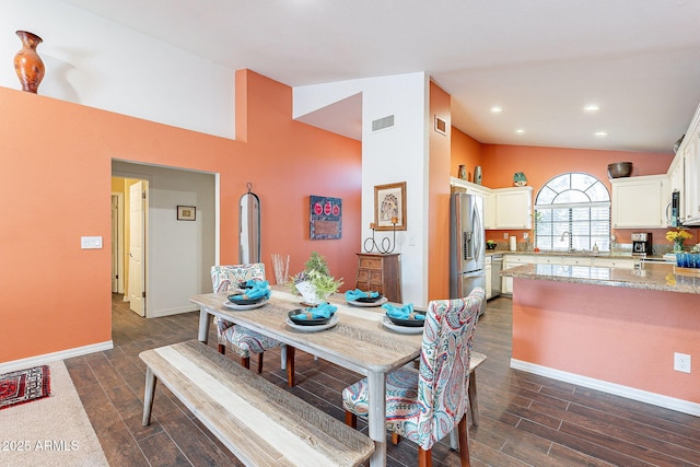 dining room featuring lofted ceiling, baseboards, visible vents, and dark wood-style flooring