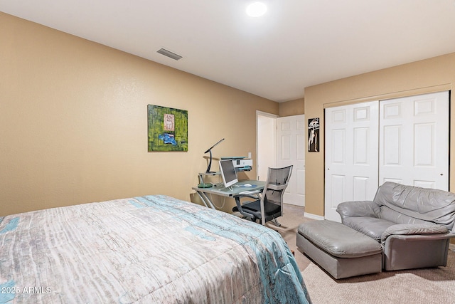 carpeted bedroom featuring baseboards, visible vents, and a closet