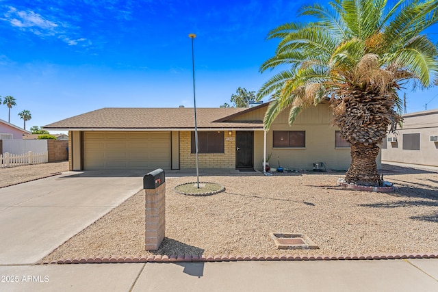 single story home with fence, driveway, and an attached garage