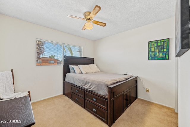 bedroom with baseboards, a ceiling fan, a textured ceiling, and light colored carpet