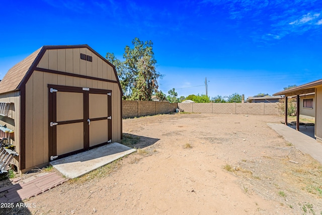 view of shed with a fenced backyard