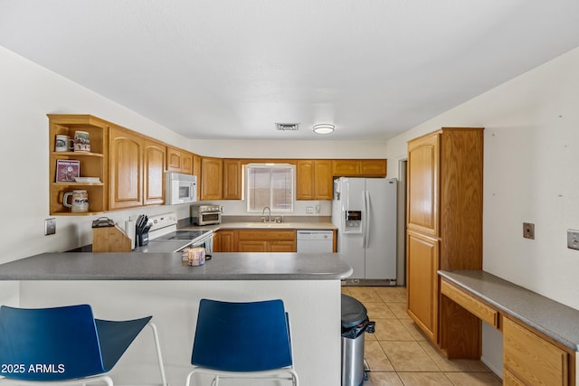 kitchen with open shelves, a sink, visible vents, white appliances, and a peninsula