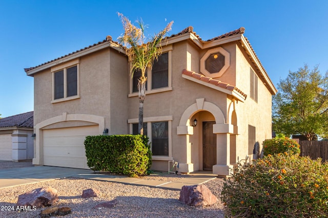 8143 E Obispo Ave, Mesa, AZ 85212 - mediterranean / spanish house featuring driveway, stucco siding, a tile roof, and a garage