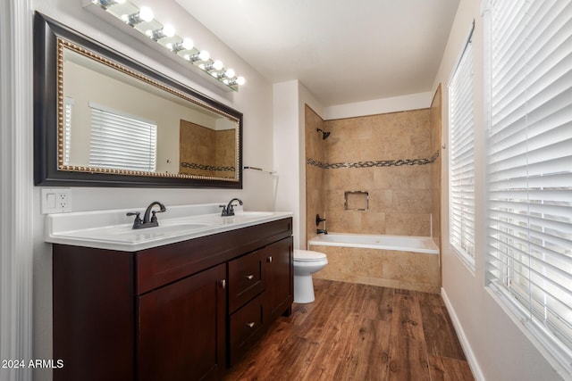 8143 E Obispo Ave, Mesa, AZ 85212 - bathroom featuring double vanity, toilet, wood finished floors, and tiled shower / bath