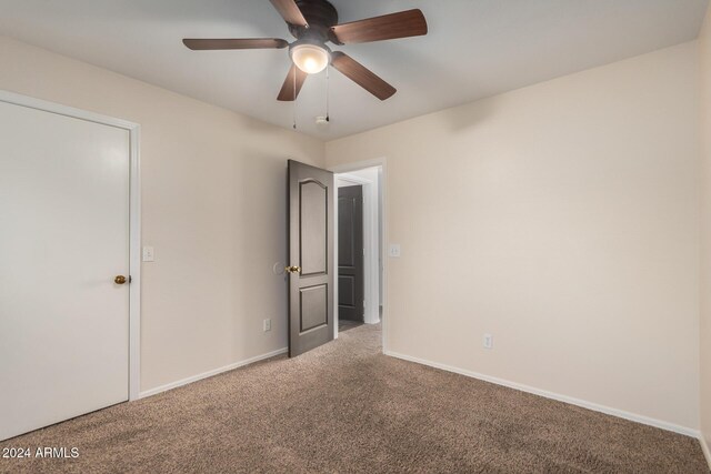 8143 E Obispo Ave, Mesa, AZ 85212 - unfurnished bedroom with carpet flooring, baseboards, and a ceiling fan
