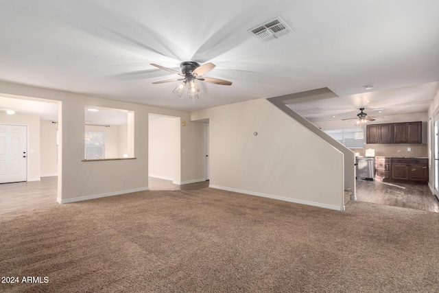 8143 E Obispo Ave, Mesa, AZ 85212 - unfurnished living room featuring ceiling fan, dark colored carpet, and baseboards