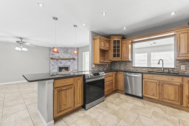 2633 E Garnet Ave, Mesa, AZ 85204 - kitchen featuring appliances with stainless steel finishes, backsplash, a peninsula, a sink, and a brick fireplace