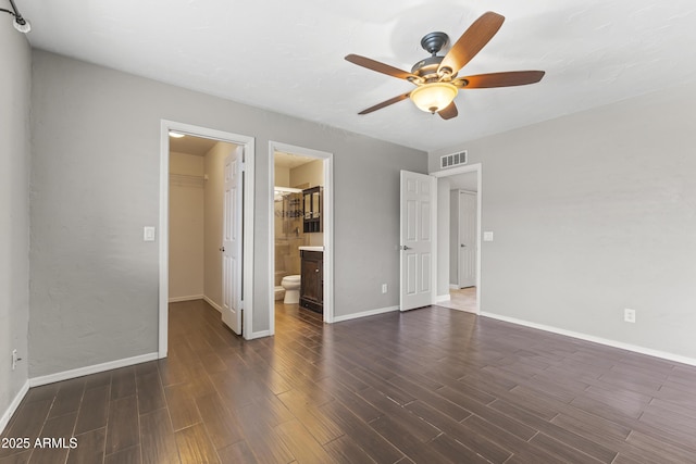 2633 E Garnet Ave, Mesa, AZ 85204 - unfurnished bedroom featuring a spacious closet, dark wood-style flooring, and baseboards