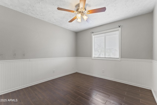 2633 E Garnet Ave, Mesa, AZ 85204 - unfurnished room with wainscoting, wood finished floors, ceiling fan, a textured ceiling, and baseboards