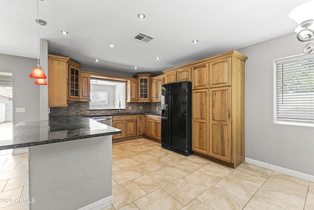 2633 E Garnet Ave, Mesa, AZ 85204 - kitchen featuring black fridge, a peninsula, glass insert cabinets, brown cabinets, and backsplash