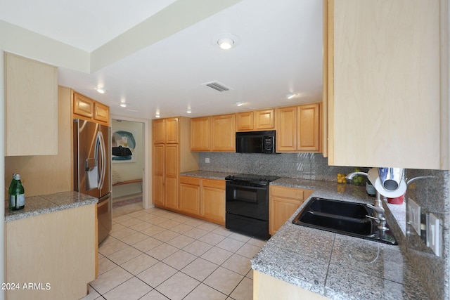 kitchen featuring decorative backsplash, light brown cabinetry, sink, and black appliances