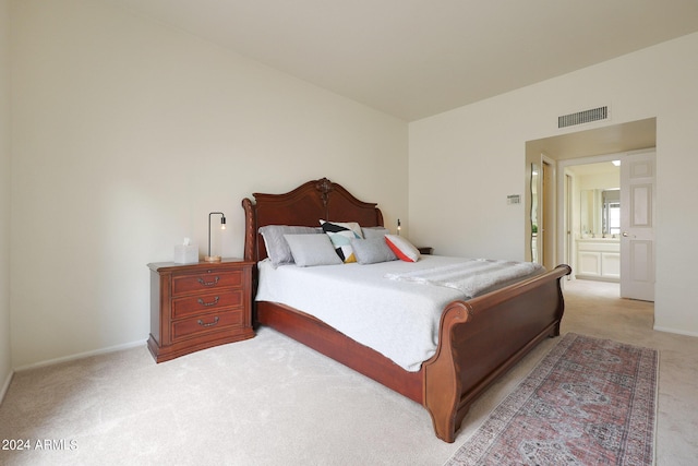 carpeted bedroom featuring connected bathroom