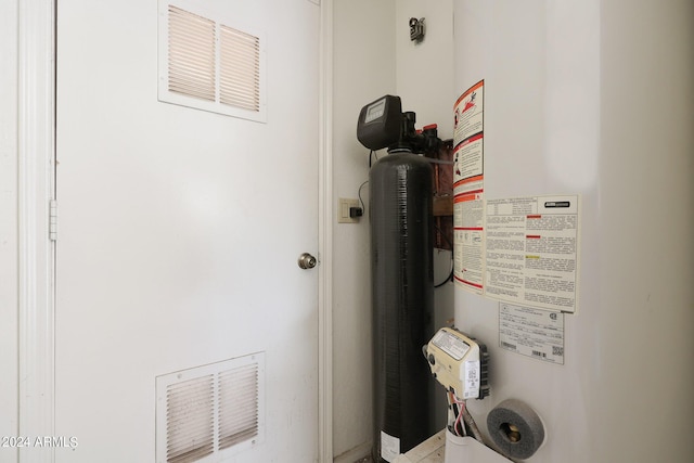 utility room featuring gas water heater