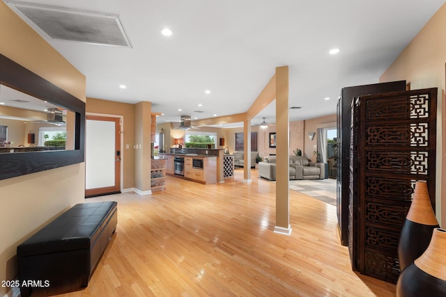 entrance foyer with ceiling fan and light hardwood / wood-style floors