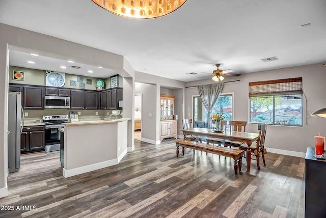 3948 W Rushmore Dr, Anthem, AZ 85086 - dining space with a healthy amount of sunlight, baseboards, visible vents, a ceiling fan, and wood finished floors
