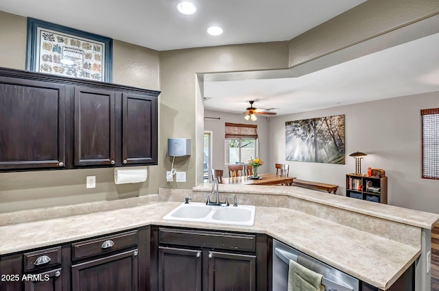 3948 W Rushmore Dr, Anthem, AZ 85086 - kitchen with a peninsula, a sink, dark brown cabinets, ceiling fan, and light countertops