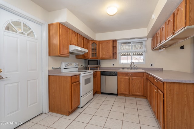 kitchen featuring sink, light tile patterned floors, and stainless steel appliances