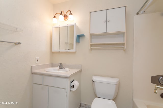 bathroom featuring vanity and toilet