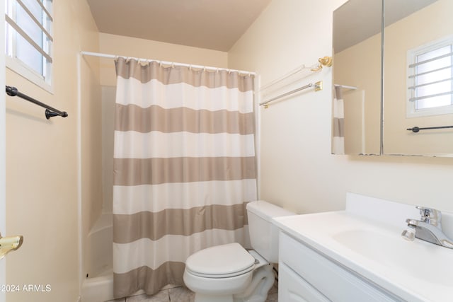 bathroom featuring vanity, toilet, and walk in shower