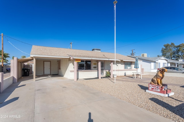 ranch-style home featuring a carport