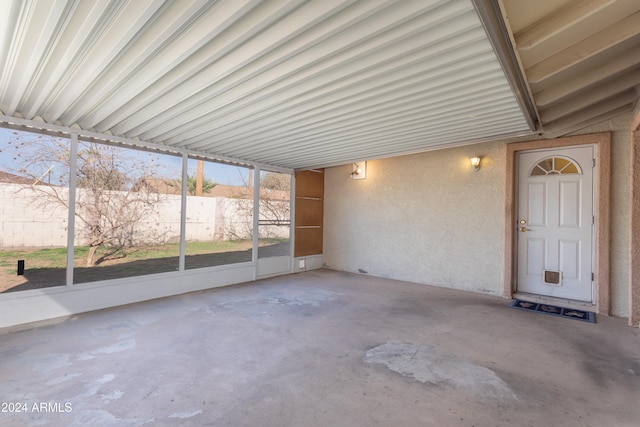 unfurnished sunroom featuring vaulted ceiling