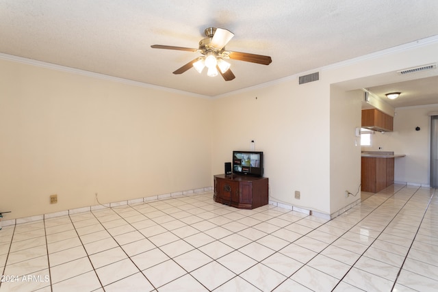 empty room with light tile patterned floors, a textured ceiling, ceiling fan, and ornamental molding