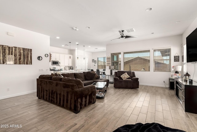 3832 W Mcneil St, Laveen, AZ 85339 - living room featuring light wood-style floors, a ceiling fan, baseboards, and recessed lighting