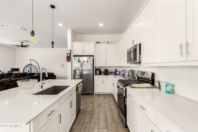 3832 W Mcneil St, Laveen, AZ 85339 - kitchen featuring appliances with stainless steel finishes, a sink, open floor plan, light countertops, and recessed lighting