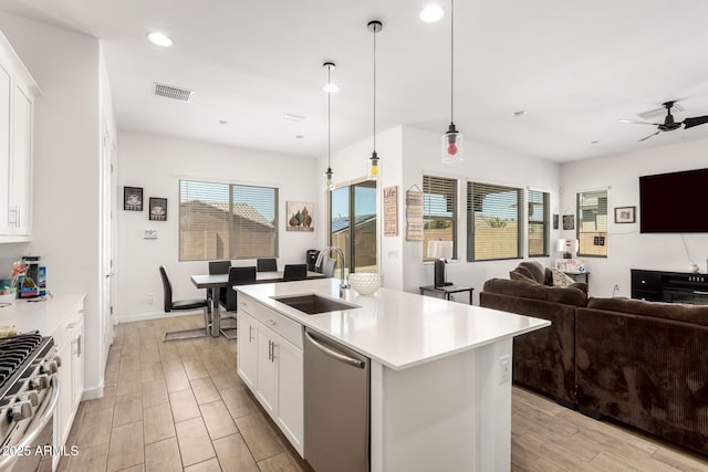 3832 W Mcneil St, Laveen, AZ 85339 - kitchen featuring a sink, open floor plan, appliances with stainless steel finishes, a ceiling fan, and light countertops