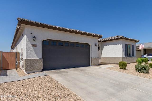 3832 W Mcneil St, Laveen, AZ 85339 - mediterranean / spanish-style home with a garage, stucco siding, and driveway