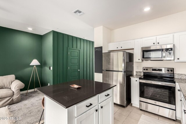 2256 W Laurie Ln, Phoenix, AZ 85021 - kitchen featuring stainless steel appliances, white cabinetry, light tile patterned floors, recessed lighting, and a kitchen island
