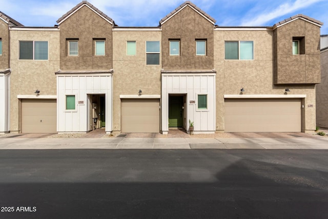 2256 W Laurie Ln, Phoenix, AZ 85021 - view of property with board and batten siding, a garage, and stucco siding