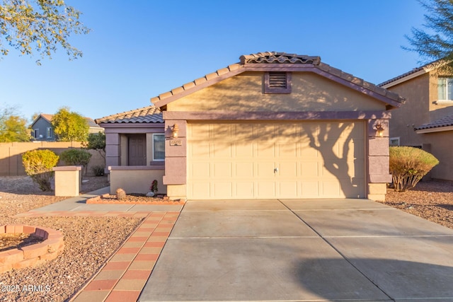 mediterranean / spanish-style home with a garage