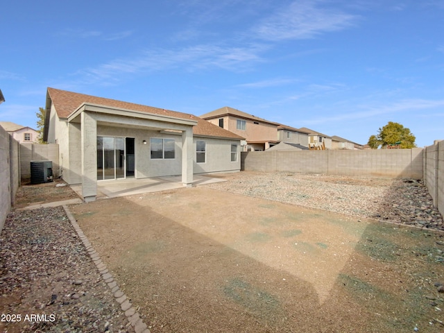 rear view of property featuring central AC unit and a patio area