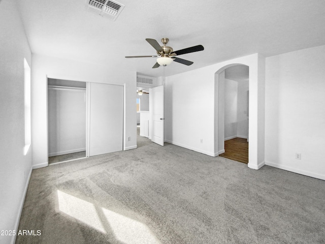 unfurnished bedroom with a closet, ceiling fan, and carpet