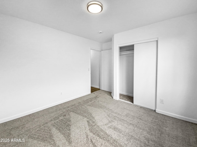 unfurnished bedroom featuring a closet and carpet