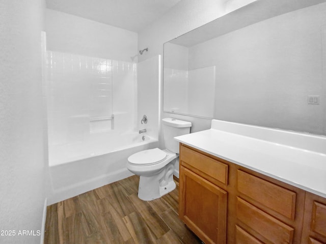 full bathroom with vanity, hardwood / wood-style flooring, toilet, and washtub / shower combination