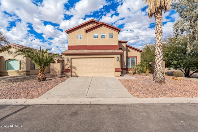 view of front of home featuring a garage, concrete driveway, and stucco siding