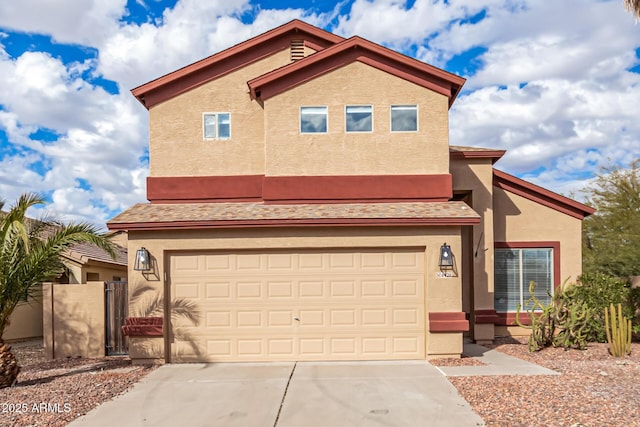 view of front facade with a garage, concrete driveway, and stucco siding