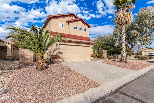 view of front of home with concrete driveway, an attached garage, and stucco siding