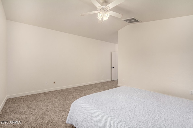 carpeted bedroom featuring ceiling fan, baseboards, visible vents, and vaulted ceiling