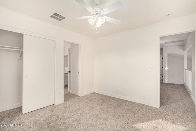 unfurnished bedroom featuring light carpet, baseboards, visible vents, and a closet