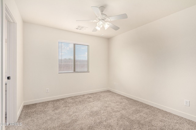 empty room featuring a ceiling fan, baseboards, visible vents, and carpet flooring